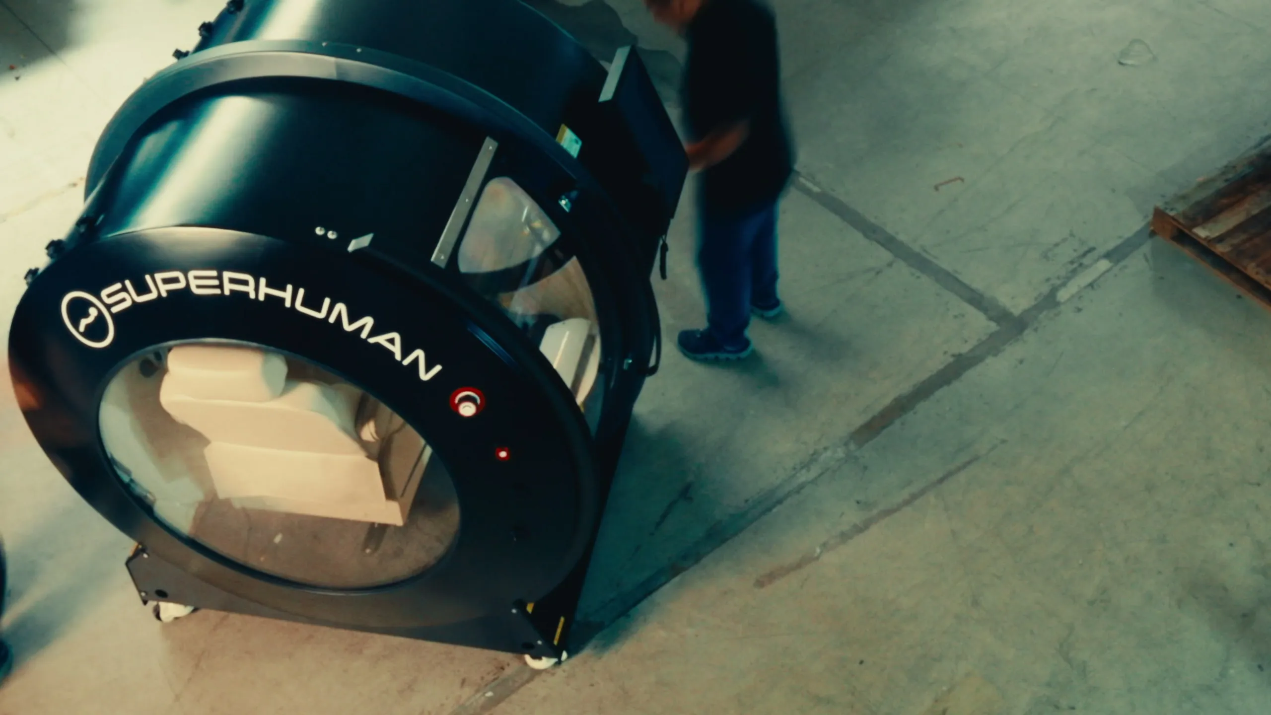 Superhuman hard-shell hyperbaric chamber, side profile with the door open